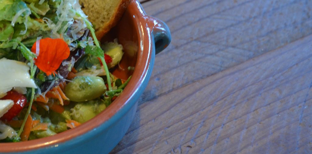 that are served on sturdy wood tables that Jason Sakach himself built…