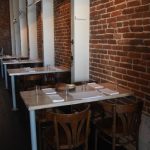 Flower + Bone – Brick wall tables with napkins and glasses
