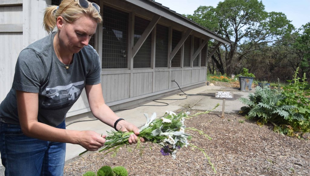 Flatbed Farm Bounces Back After Fires with Sofie Dolan putting together a bouquet of spring flowers