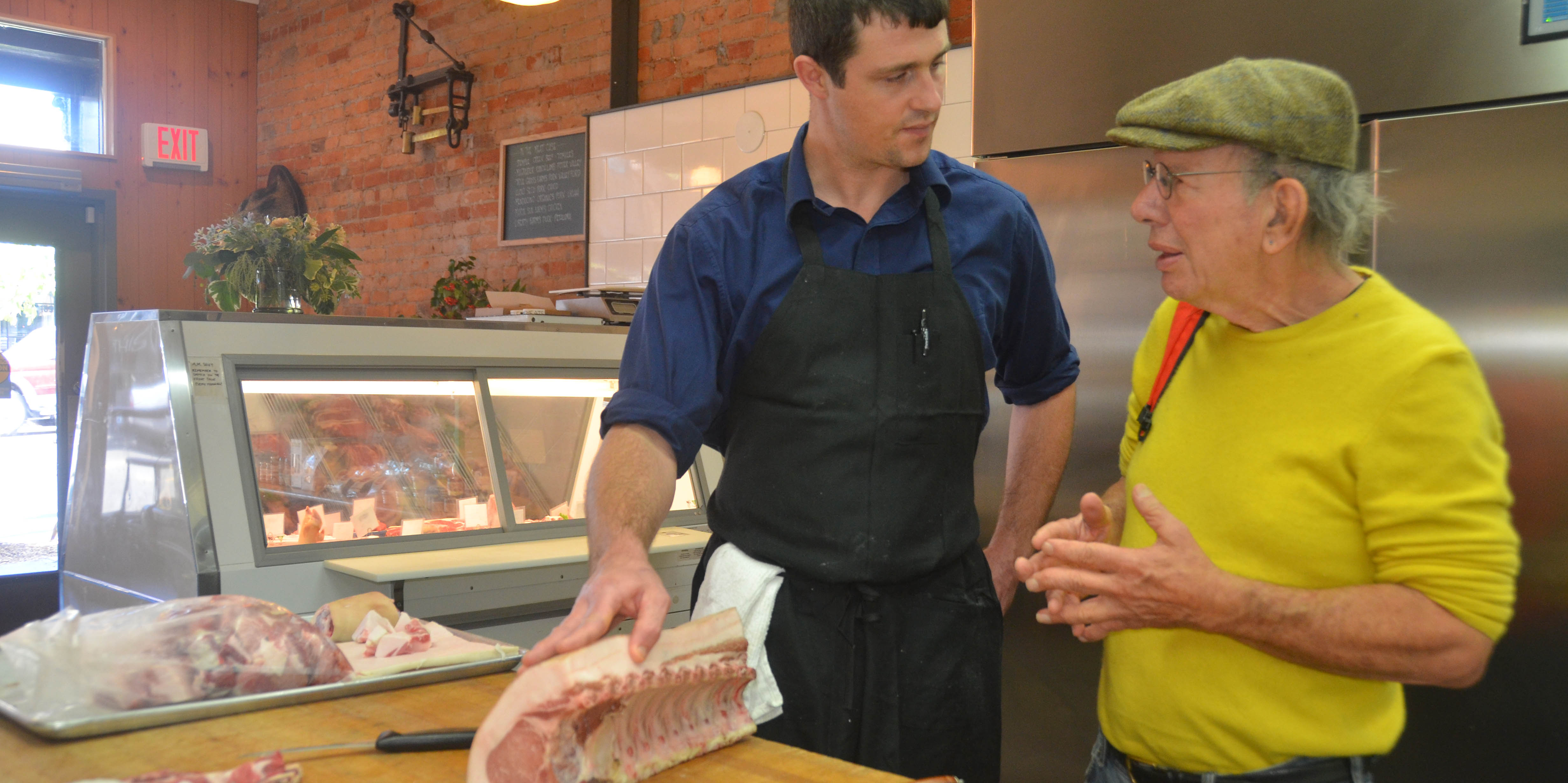 Jona Raskin talks with his butcher, John Richter, at Thisle Meats in Petaluma, California